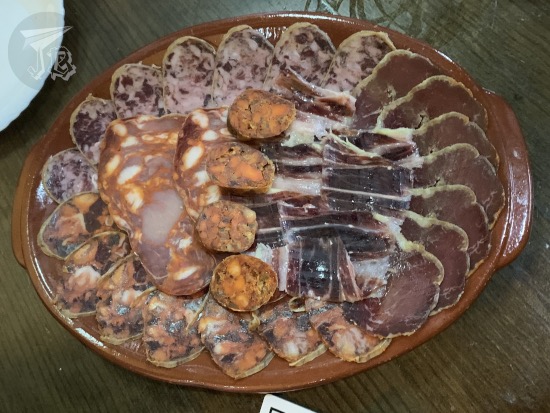A plate of sausage slices and ham