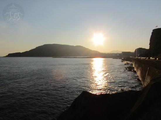 The sun rising along a promenade